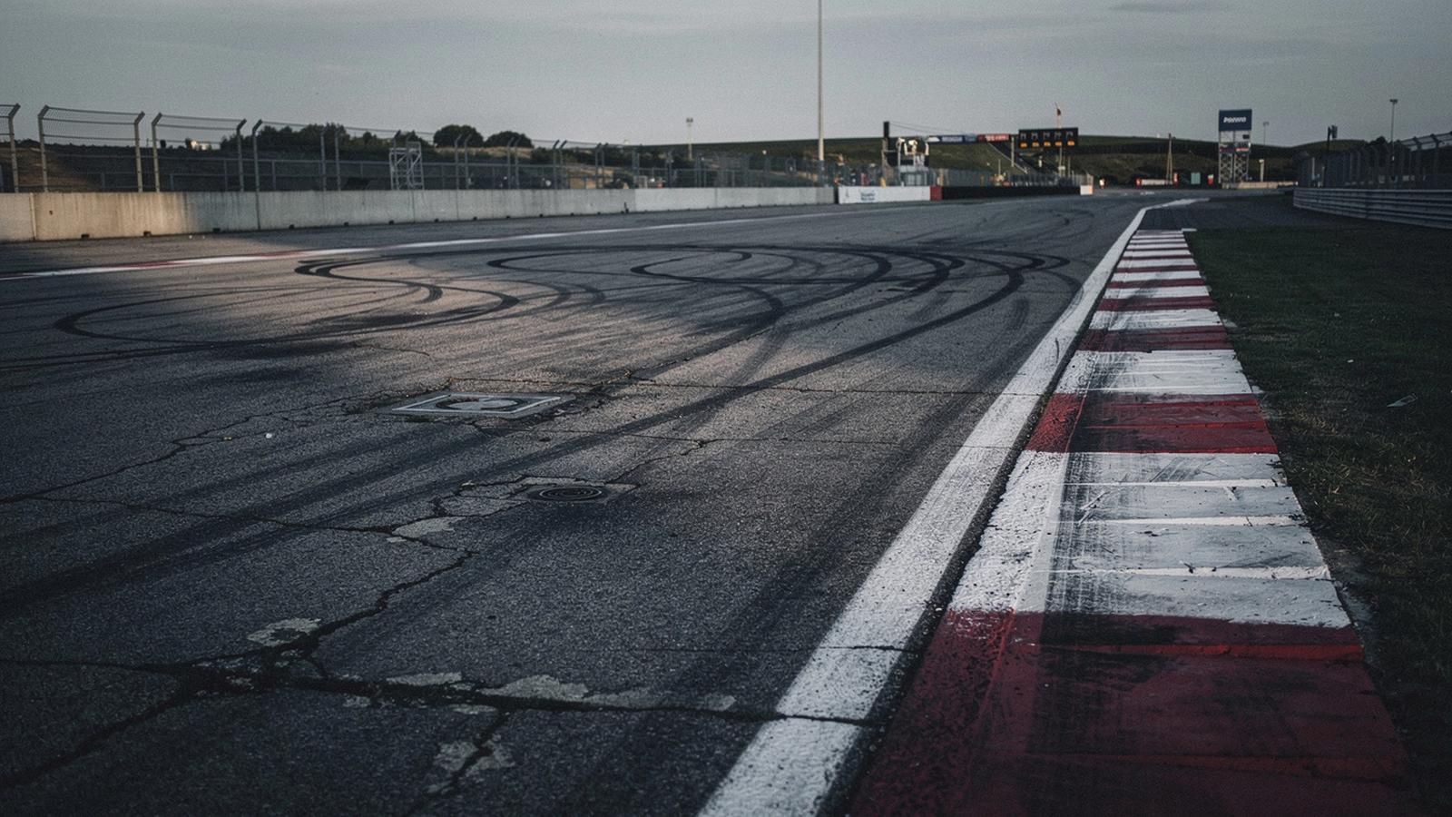 Worn asphalt edge and painted kerb line at the closed circuit near Kyiv